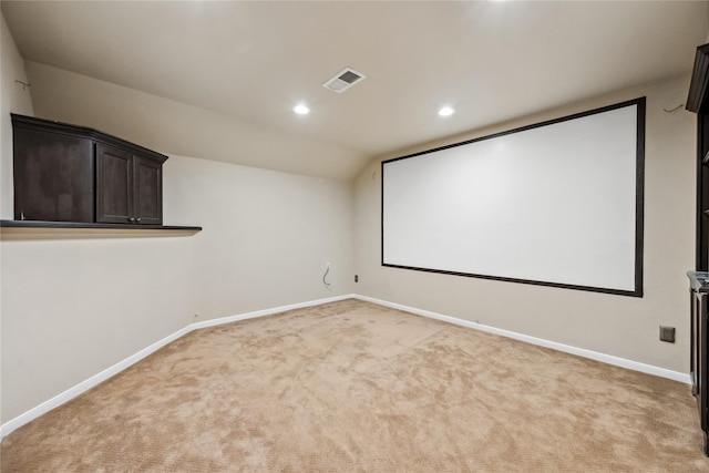 cinema room with visible vents, light carpet, lofted ceiling, recessed lighting, and baseboards