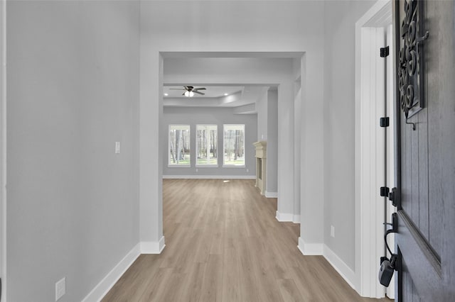 hallway with baseboards and light wood-type flooring