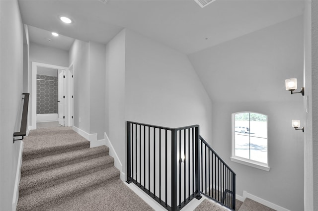 stairway featuring vaulted ceiling, carpet flooring, recessed lighting, and baseboards