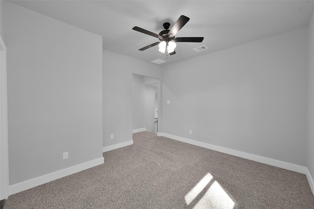 empty room featuring visible vents, carpet flooring, a ceiling fan, and baseboards