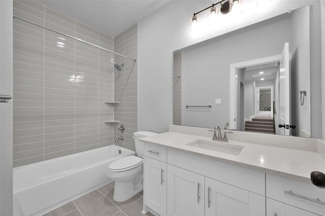 bathroom featuring tub / shower combination, toilet, vanity, and tile patterned floors