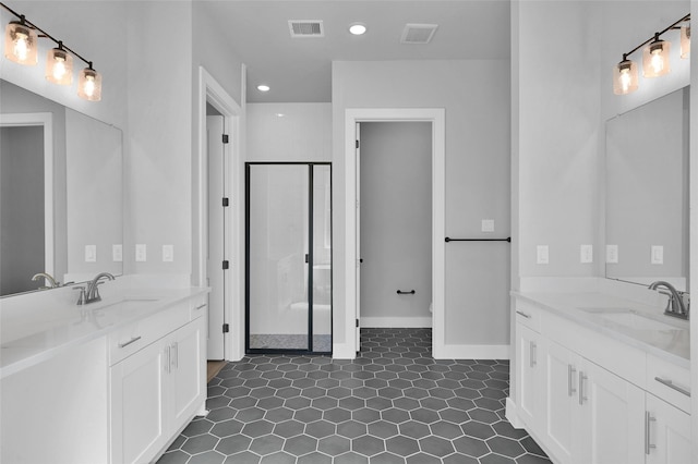 bathroom featuring a sink, visible vents, two vanities, and a stall shower