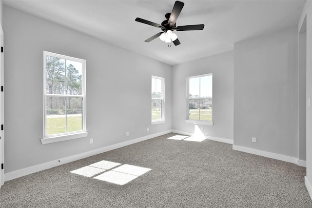 empty room with baseboards, carpet floors, and a ceiling fan