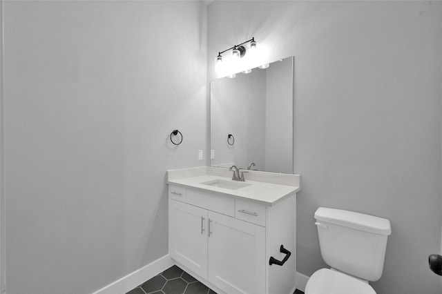 bathroom with vanity, tile patterned floors, toilet, and baseboards