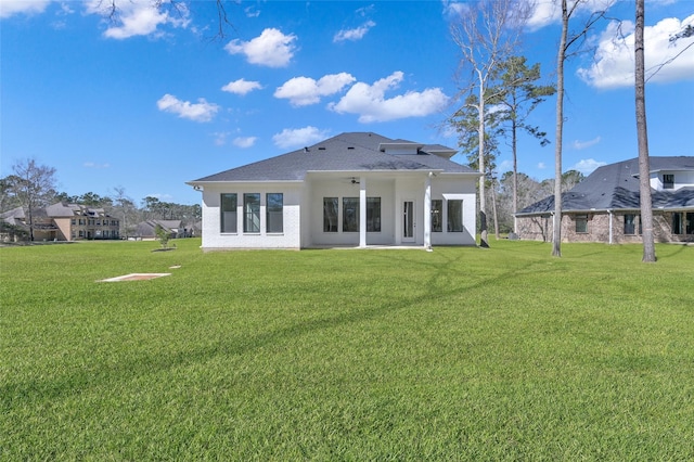 back of house with a yard and ceiling fan