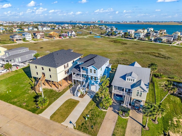 drone / aerial view featuring a residential view and a water view