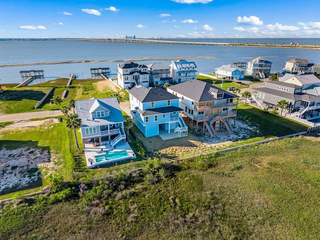 drone / aerial view featuring a residential view and a water view