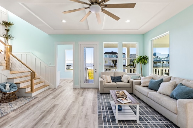 living area featuring wood finished floors, recessed lighting, stairway, baseboards, and ceiling fan