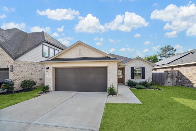 view of front of home with brick siding, driveway, a front yard, and a garage