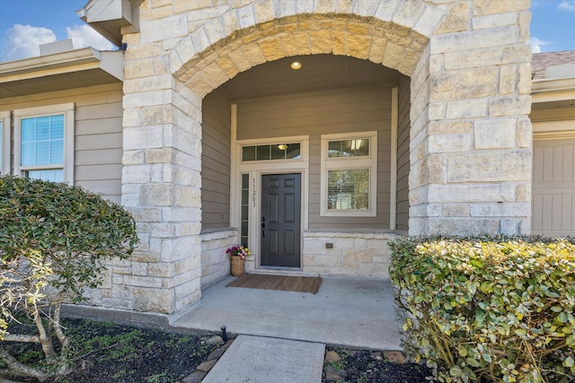 property entrance with stone siding