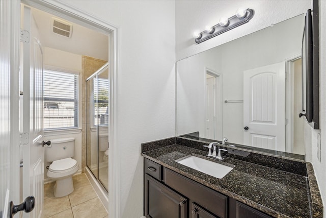 full bath with visible vents, toilet, a stall shower, tile patterned flooring, and vanity