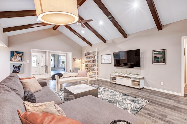 living area featuring baseboards, ceiling fan, and wood finished floors