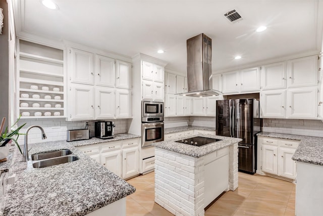 kitchen with visible vents, a sink, stainless steel appliances, white cabinets, and island range hood