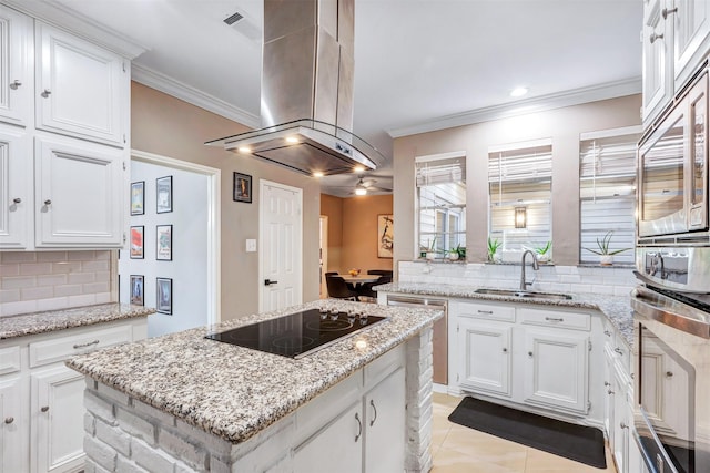 kitchen with island range hood, ornamental molding, appliances with stainless steel finishes, tasteful backsplash, and a center island