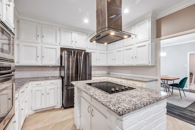 kitchen with a kitchen island, crown molding, island exhaust hood, stainless steel appliances, and white cabinetry