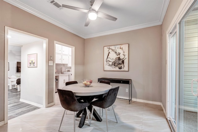 dining area with light tile patterned floors, visible vents, baseboards, and ornamental molding