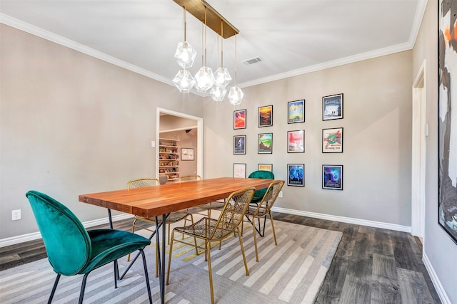 dining area featuring baseboards, wood finished floors, and crown molding