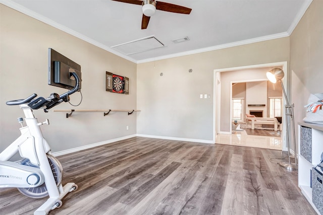 workout room featuring visible vents, ornamental molding, wood finished floors, baseboards, and attic access