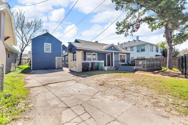 view of front of house with a deck and fence