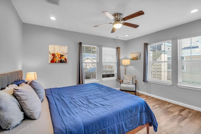 bedroom featuring visible vents, a ceiling fan, wood finished floors, recessed lighting, and baseboards