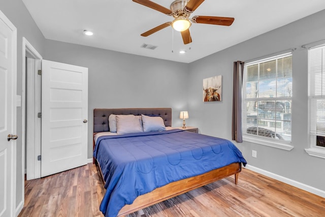 bedroom with wood finished floors, visible vents, baseboards, recessed lighting, and ceiling fan