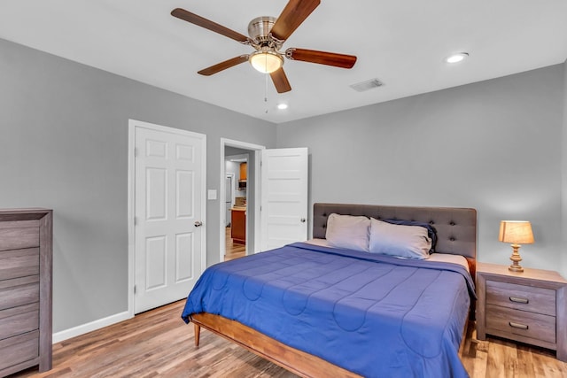 bedroom featuring visible vents, a ceiling fan, wood finished floors, recessed lighting, and baseboards