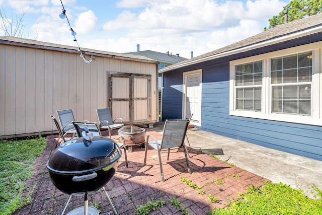 view of patio / terrace featuring an outdoor fire pit