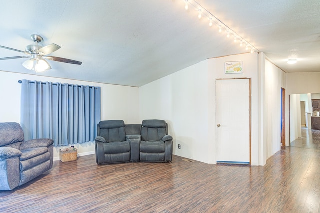 sitting room featuring a ceiling fan, lofted ceiling, and wood finished floors