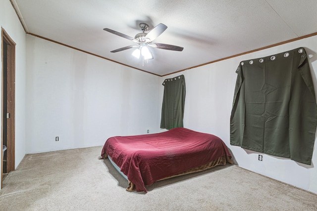 carpeted bedroom with a textured ceiling, crown molding, and ceiling fan