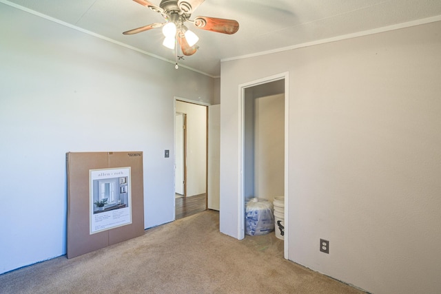 unfurnished bedroom featuring ceiling fan, carpet flooring, and ornamental molding