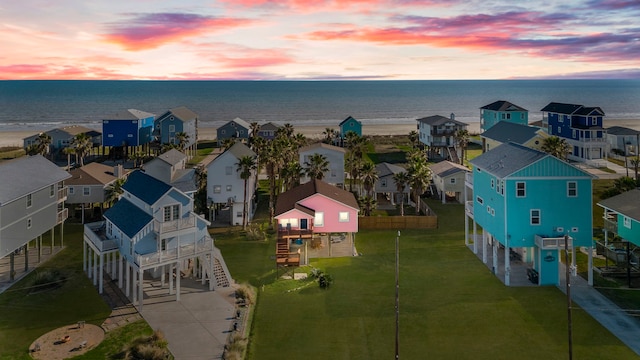 drone / aerial view featuring a residential view and a water view