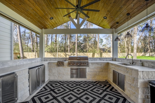 view of patio with a sink, area for grilling, a grill, and fence