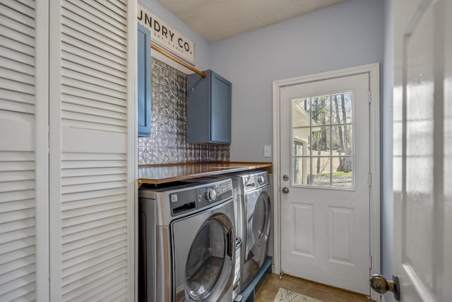 washroom featuring cabinet space and independent washer and dryer