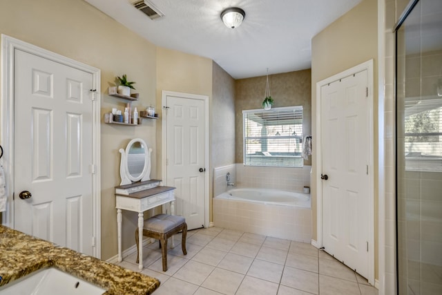 bathroom with visible vents, a garden tub, a stall shower, tile patterned flooring, and vanity