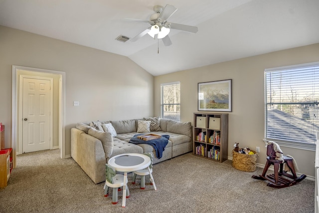 carpeted living area with visible vents, baseboards, a ceiling fan, and vaulted ceiling