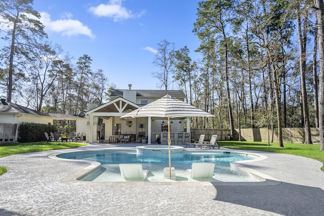 view of swimming pool with a patio, a fenced backyard, a lawn, and a pool with connected hot tub