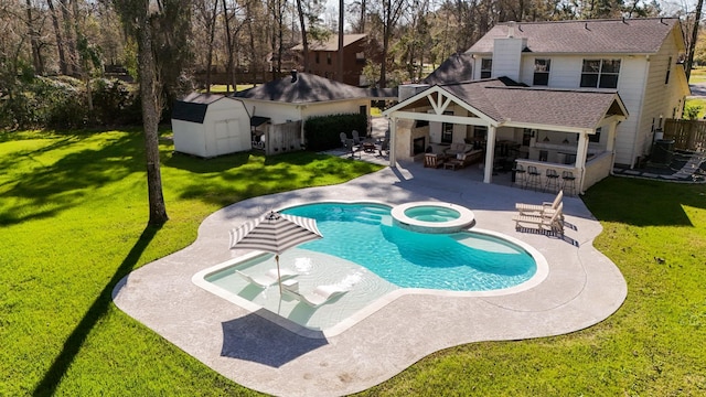 view of pool with a storage shed, a lawn, an outbuilding, and outdoor dry bar