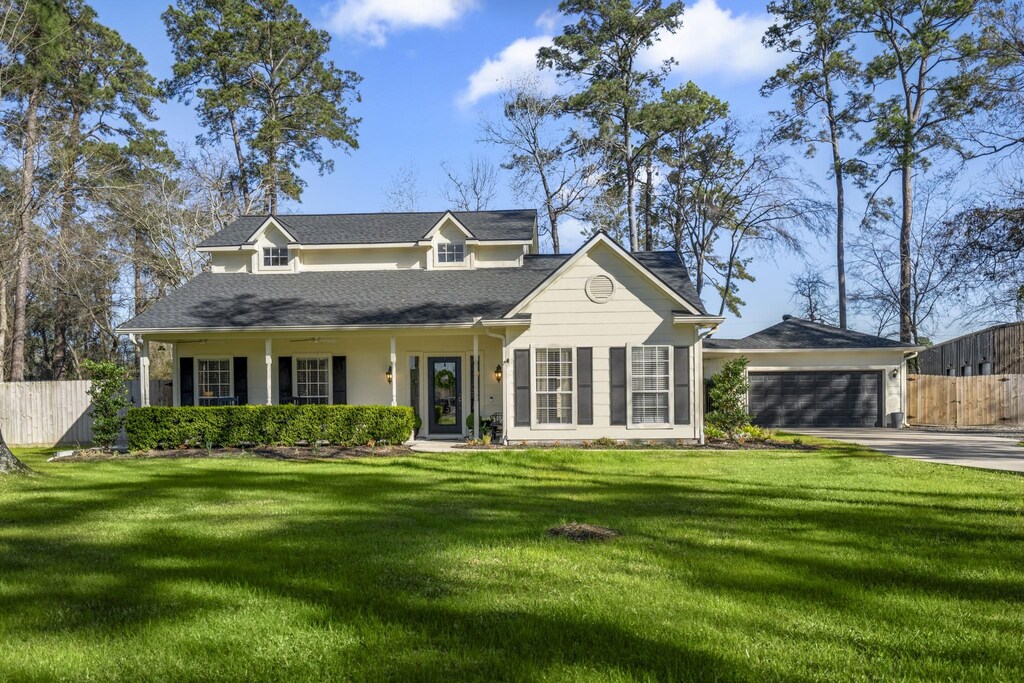 11926 Silver Leaf Ct, Conroe, TX 77385 - view of front of home with a garage, driveway, a front lawn, and fence