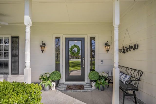 view of exterior entry featuring covered porch