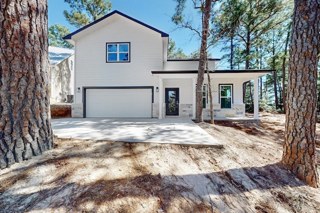 view of front of home with covered porch, driveway, and an attached garage