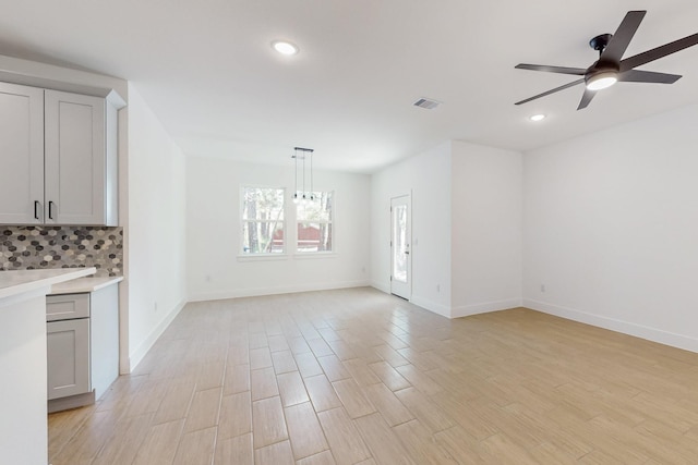 interior space featuring light wood finished floors, visible vents, baseboards, ceiling fan, and recessed lighting