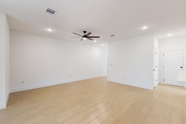 spare room featuring visible vents, recessed lighting, light wood finished floors, baseboards, and ceiling fan