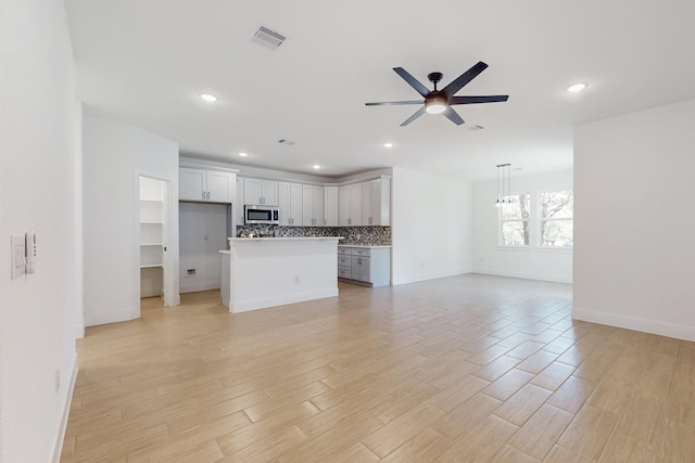 unfurnished living room with visible vents, recessed lighting, light wood-style floors, and ceiling fan