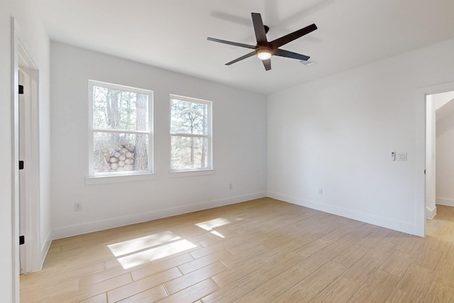 unfurnished room featuring ceiling fan, light wood-type flooring, and baseboards