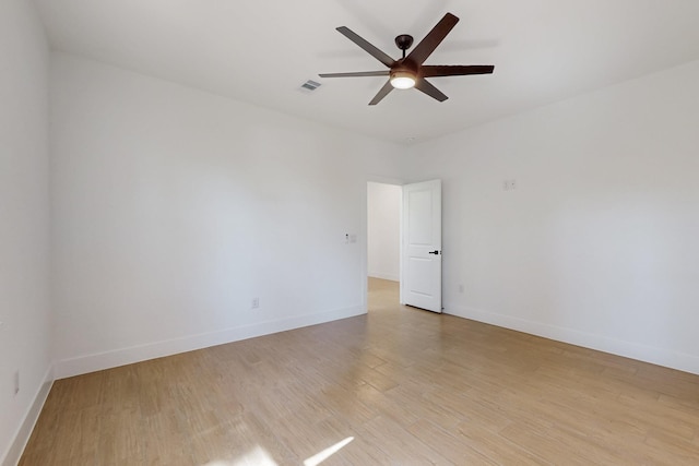 unfurnished room featuring visible vents, ceiling fan, baseboards, and light wood-style floors