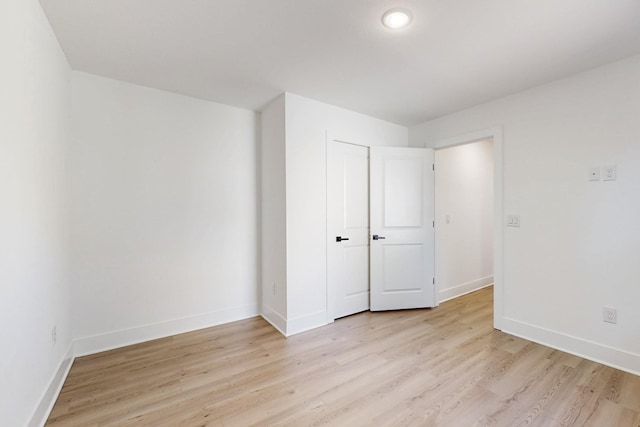 unfurnished bedroom with light wood-style floors and baseboards