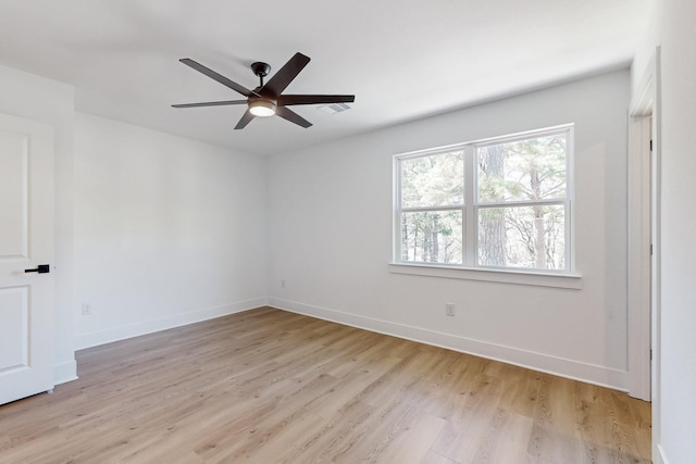 unfurnished room featuring ceiling fan, baseboards, and light wood-style floors