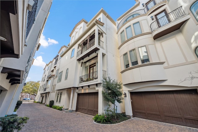 view of building exterior featuring driveway and an attached garage