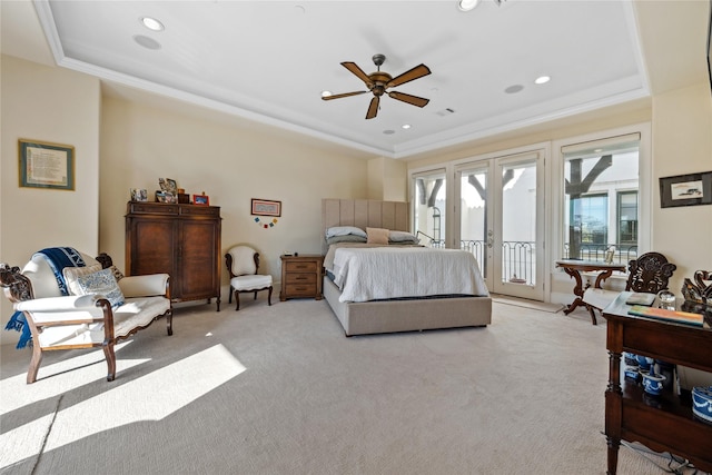 bedroom with a tray ceiling, ornamental molding, french doors, and access to outside