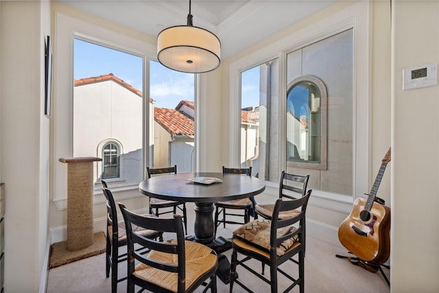 carpeted dining room featuring baseboards